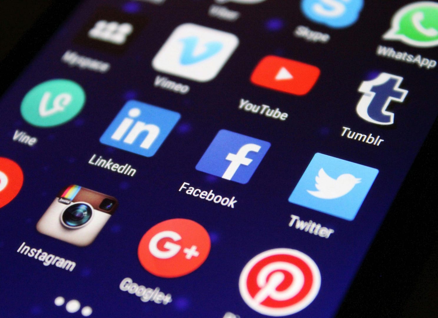 Close-up of a local smartphone screen showing various social media app icons such as Facebook and Twitter.