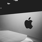 Close-up of a black and white Apple logo on a desktop screen with a modern minimalist design.